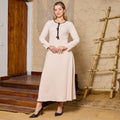 Elegant Beige Long-Sleeved Dress with Black Trim and Decorative Knots